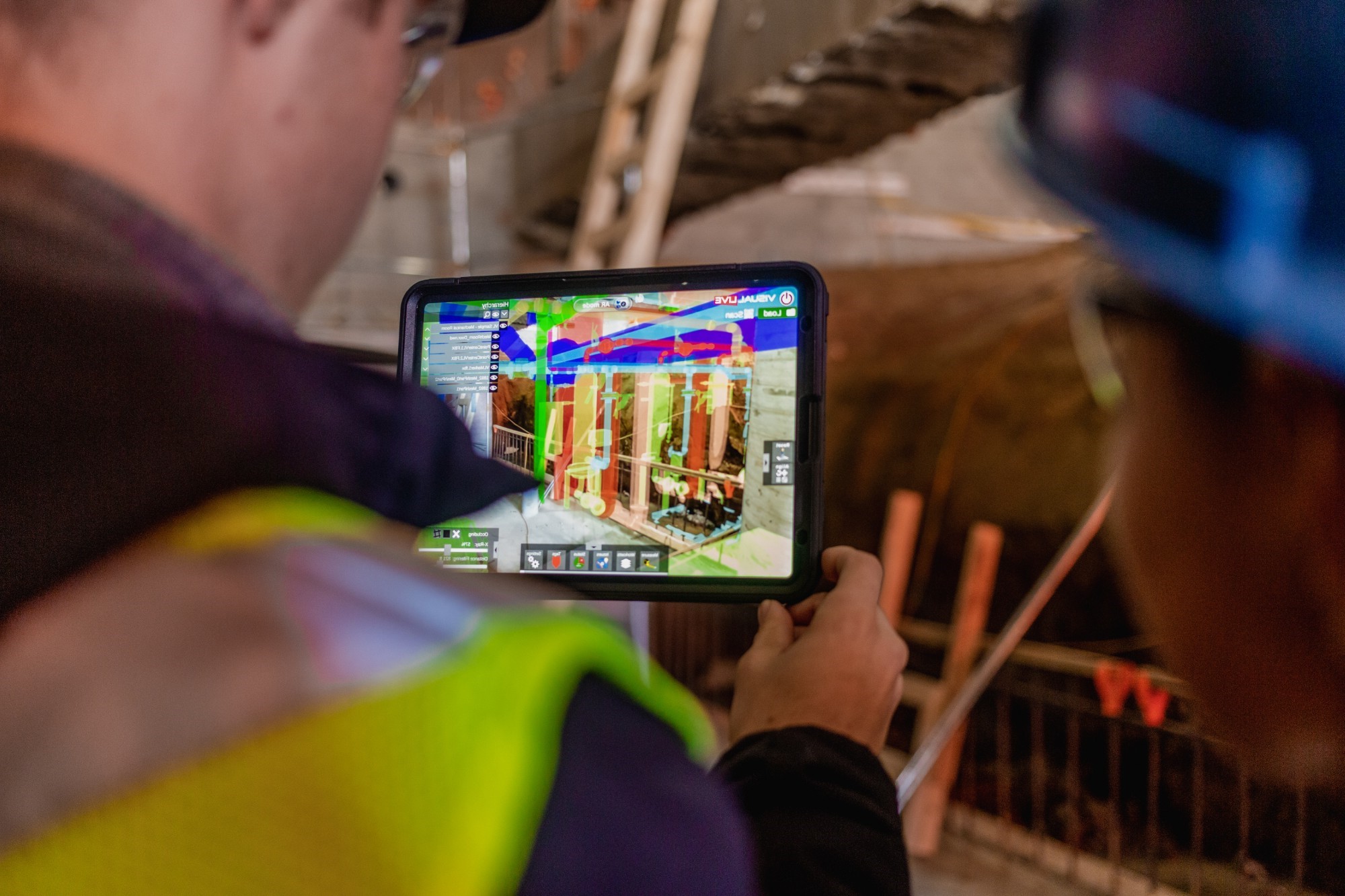 A women and a man on construction site, using design technology to virtually see completed utilities.