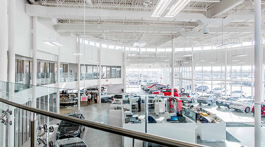 A shot of the inside of the Kingsway Toyota building, looking down onto a large reception area surrounded by cars.