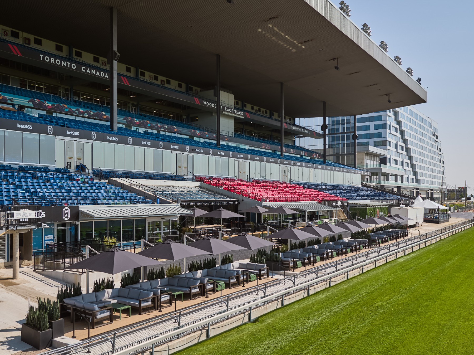 Drone image of the Woodbine Apron Patio, built by Chandos Construction Toronto. The image highlights the patio seating and panoramic views of the racetrack.