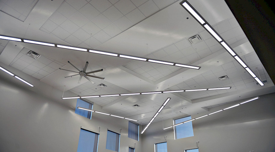A white ceiling with long, thin horizontal light fixtures.