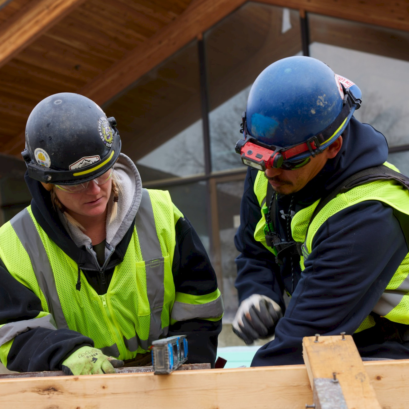 Two Chandos construction workers pointing at a site from afar.