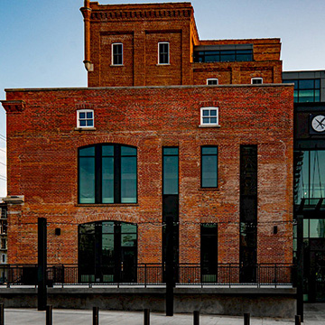A photo of a brick building with black details in the historic brewery district in Edmonton, Alberta.