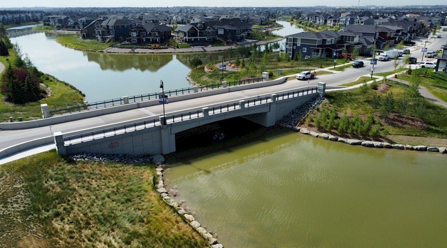 Image of the completed canal bridge with water running underneath, built by Chandos Construction Civil team.