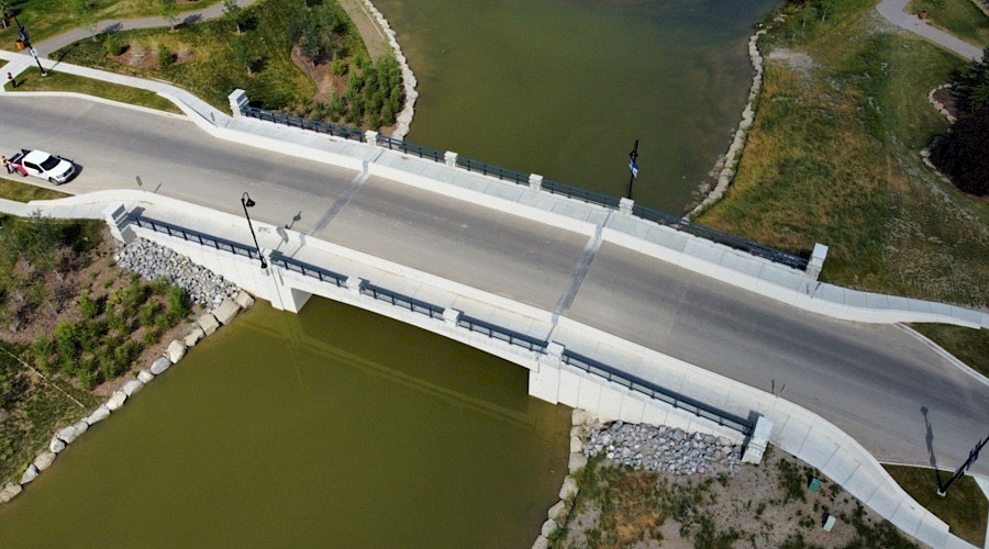 Image of the completed canal bridge with water running underneath, built by Chandos Construction Civil team.