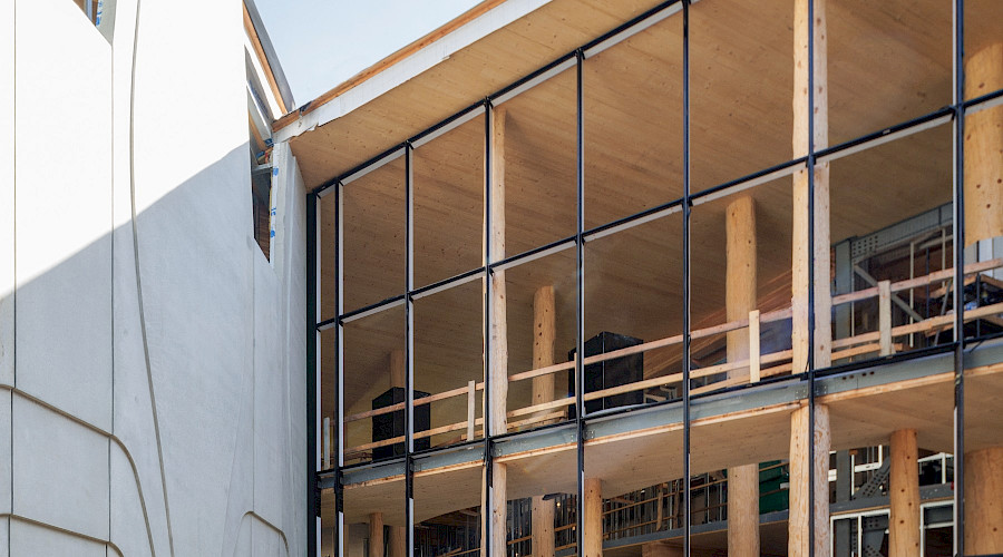 Exterior shot of new windows and construction happening at the National Centre for Indigenous Law, completed by Chandos Construction Vancouver. Showcasing the mass timber structure